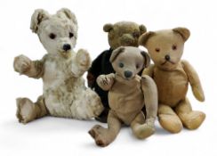 An early 20th century jointed bear, button eye, long nose, horizontal stitched nose, 35cm long, c.