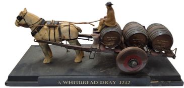 A model of a Whitbread Dray 1742, a single Shire horse pulling a three barrel cart and driver,