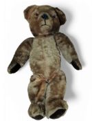 A mid 20th century jointed bear, with large eyes, large ears, velvet pads, 48cm high, c.1950
