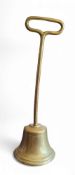 A 19th century brass country house door stop or porter, posted loop handle, the bell shaped base