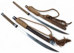 Two Burmese dha swords, each with curved tapered single-edged blade, wire bound hilt and