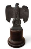 A German Nuremberg Reichsadler (Imperial eagle) desk weight, cylindrical wooden base, 16cm high