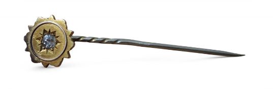 A Victorian 15ct gold and diamond stick pin, the Etruscan head centrally set with an old cut