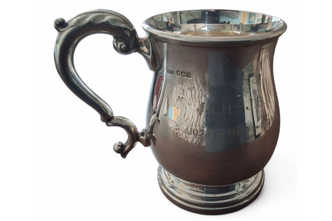 A silver baluster shaped tankard, scroll handle, engraved J.C.H. - J.B.I. 1952 -> 1964 -> 1994?,