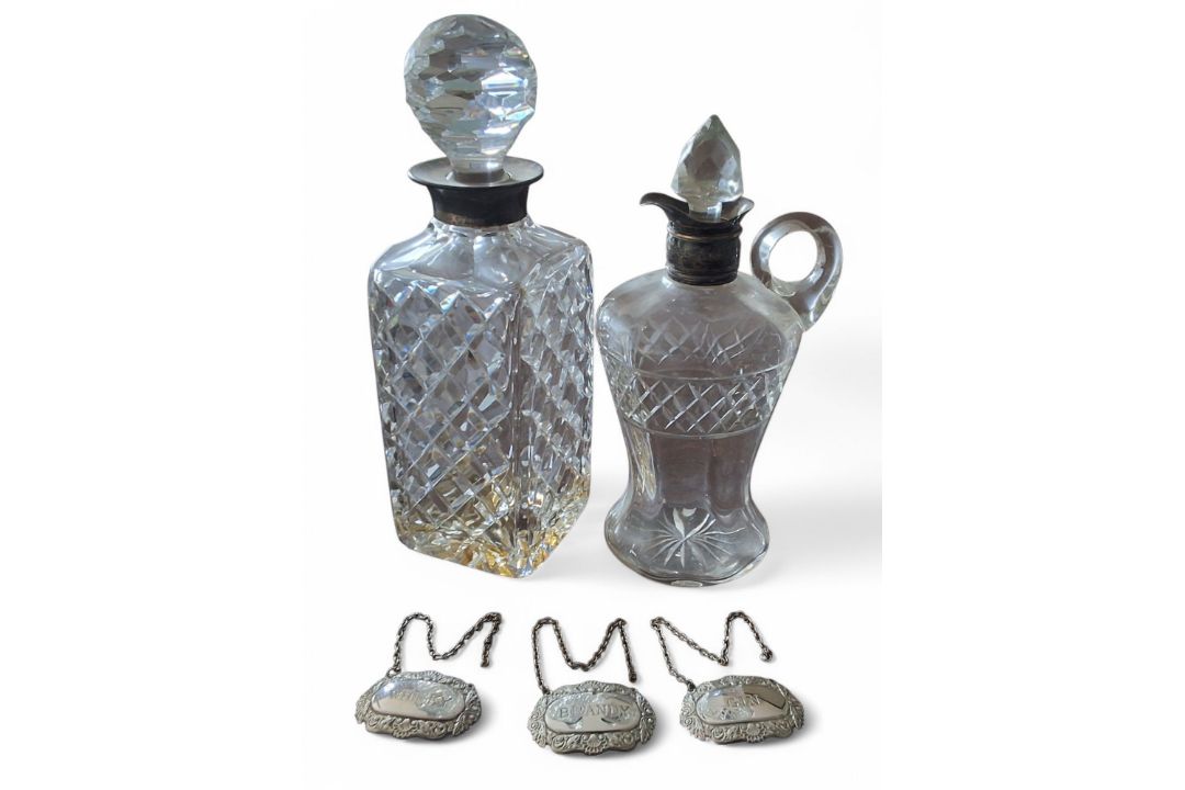 A silver collared cut glass whisky decanter, Garrard & Co Ltd, Birmingham, 1959; an Edwardian silver