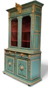 A 19th century French Napoleon III bookcase, the cornice with oversize mask to centre above two