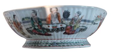 A Chinese famille rose lobed fruit bowl, decorated to the exterior with the Eight Immortals and