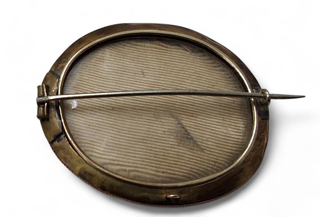 A Victorian gilt metal mourning brooch, oval banded onyx cabochon, banded black enamel border, - Image 2 of 2