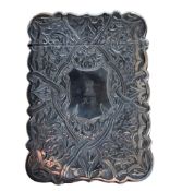 A Victorian silver shaped rectangular card case, with shield shaped cartouche, engraved and chased
