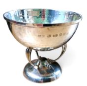 An Arts and Crafts style planished silver pedestal bowl, three pierced C-scroll legs, domed base,