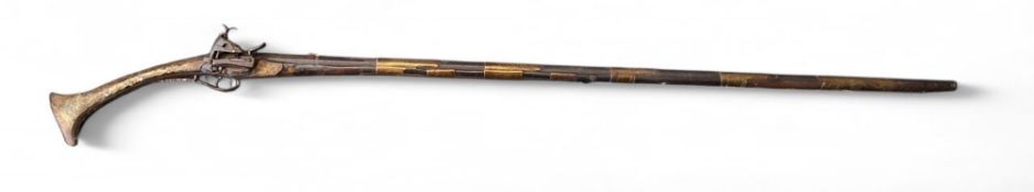 An Albanian Miquelet Lock long gun or Tanchika, 122cm sighted barrel, applied brass and mother of