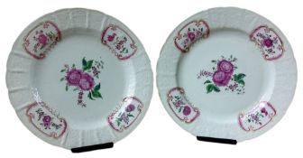 A pair of Chinese shaped circular plates, painted in the famille rose palette with stylised roses,
