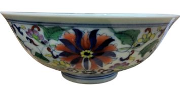 A Chinese Ducai style footed bowl, decorated with stylised flowers and foliage, in cobalt blue, red,