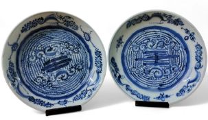 A pair of composed Japanese circular plates, decorated in underglazed blue with scrolls and symbols,