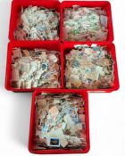 Stamps- World stamp accumulation on and off paper sorted in five plastic containers. Many tens of