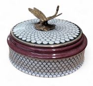 A contemporary circular box, painted with scales, the cover with brass dragonfly,  10cm high, 13cm