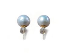 A pair of 18ct gold and pearl studs, the freshwater pearl, each approx. 10mm dia., the post
