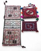 A Northern Afghanistan camel saddle bag carrier, geometric design, in tones of brown, 93cm long,