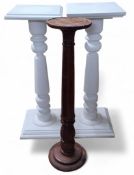 A mahogany torchere, turned and carved support 100cms high; another two painted white (3)