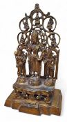 A Chinese Tibetan bronze shrine, three buddhist deities stood on a plinth, smaller seated buddha