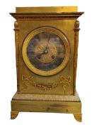 A late 19th century brass mantel clock, the 12.5cm diam with Roman numerals, the rectangular case