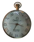 A contemporary globular magnification desk time piece, Roman numeral, the face inscribed 'Omega'
