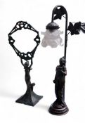 A bronzed Art Nouveau vanity mirror, cast with a lady wearing a flowing dress holding aloft a