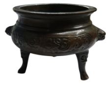 A Chinese bronze ding tripod censer, mask handles, 8cm high, 12cm diam, seal mark