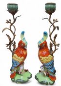 A pair of reproduction Meissen style candlesticks, modelled as parrots, gilt metal mounted, 38cm