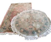 A woollen carpet, with roundels and flowerheads on a pink ground, 185cm x 116cm;   another, Chinese,
