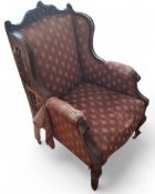 A Victorian walnut side chair, with carved leafy cresting, stuffed over back, seat and arms,