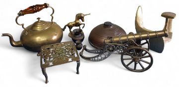 A large brass desk cannon, 33cms long; a brass trivet; a brass kettle; etc.