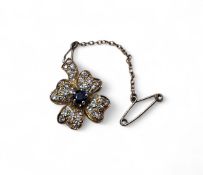 An 18ct gold, solitaire and diamond brooch in the form of a flower, a centrally six claw set round