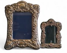 A Victorian style silver easel photograph frame, embossed with cherubs and scrolls, 22.5cm high,