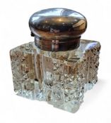 An Edwardian silver and glass inkwell, of large proportions, hinged domed cover, facetted and