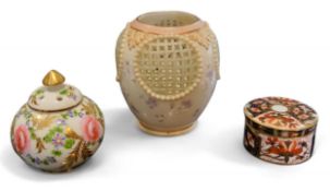 A Doulton ovoid vase, four circular pierced roundels, scattered blossom, 8.5cm high, printed mark; a