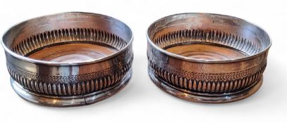 A pair of George III Old Sheffield Plate circular wine coasters, engraved leafy band above