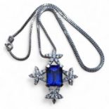 A privately commissioned white metal, tanzanite and diamond pendant, the centrally set emerald cut