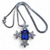 A privately commissioned white metal, tanzanite and diamond pendant, the centrally set emerald cut