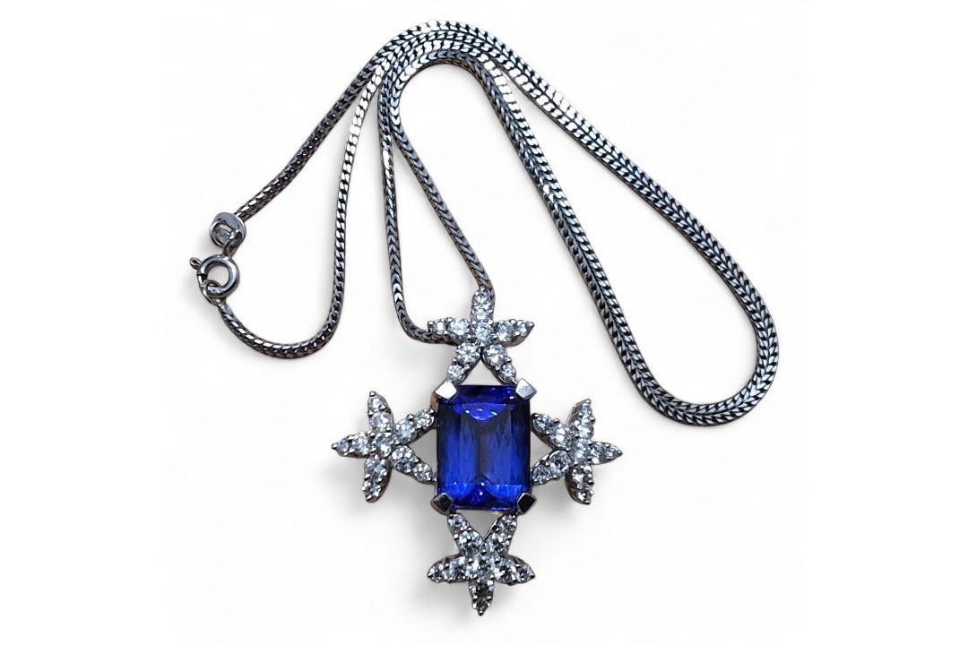 A privately commissioned white metal, tanzanite and diamond pendant, the centrally set emerald cut - Image 1 of 2