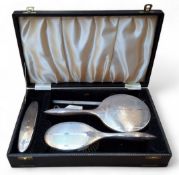 An Art Deco silver four piece dressing table set, comprising hair brush, mirror, clothes brush and