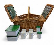 A Land Rover wicker hamper, with four mugs, flatware and Tupperware, 53cm wide