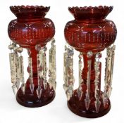 A pair of Victorian ruby glass lustres, picked out in white enamel with stylised flowerheads and