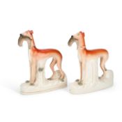 A PAIR OF VICTORIAN STAFFORDSHIRE POTTERY GREYHOUND COURSING FIGURES
