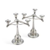 A RARE PAIR OF LIBERTY & CO TUDRIC PEWTER THREE-LIGHT CANDELABRA