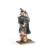 AN AUSTRIAN COLD-PAINTED METAL FIGURAL TABLE LIGHTER MODELLED AS A PIPING GORDON HIGHLANDER