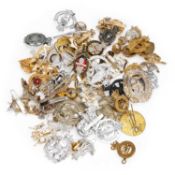 A GROUP OF STAYBRITE CAP BADGES