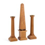 DAVID LINLEY A SYCAMORE AND WALNUT OBELISK TABLE ORNAMENT AND A PAIR OF CANDLESTICKS