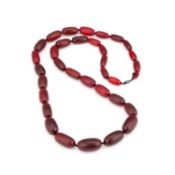 A STRING OF STAINED RHINOCEROS HORN GRADUATED BEADS LATE 19TH CENTURY