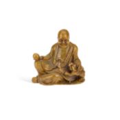 A CHINESE SOAPSTONE FIGURE